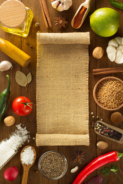 herbs and spices on wood background