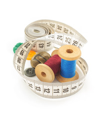 sewing tools and measuring tape on white