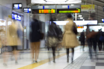 Corporate business people commuting to work by Tokyo public transport. Unrecognizable people blured in motion while rushing to train platforms. © kasto