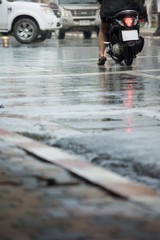 Wet road and rainy day in the city.Blurry soft focus background.