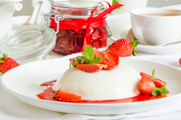 Italian dessert pannacotta with strawberry sauce