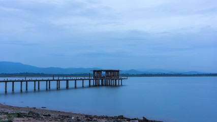 Fototapeta na wymiar Long exposure of abandoned bridge at Bang Phra Reservoir in the evening , Si Racha District , Chonburi Province, Thailand