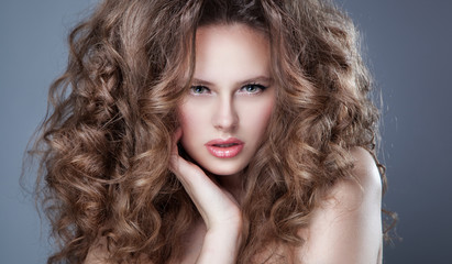 Fototapeta premium Portrait of beautiful blonde woman with curly hairstyle and brig