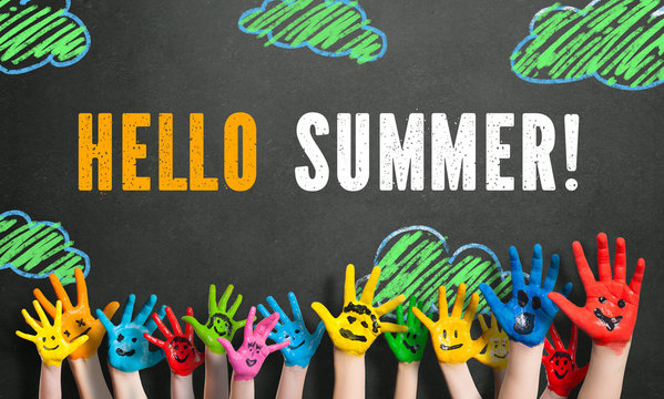 painted kids hands with chalk message "Hello Summer!"