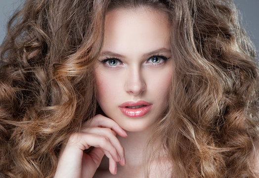 vogue style portrait of beautiful delicate woman with curly long