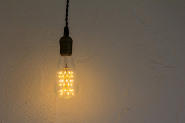 Lightbulb hang on white wall