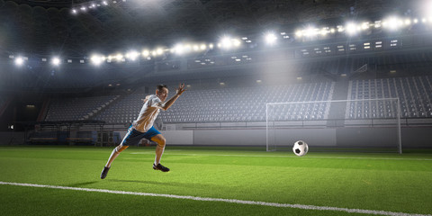 Soccer player hitting ball
