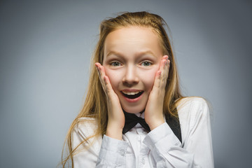 Closeup Portrait of happy girl going surprise isolated on gray background