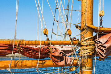 Old wooden mast with sails on a sailing ship