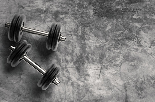 metal dumbbell on cement background