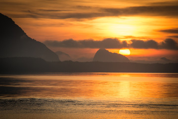 Beautiful nature sunrise at sea mountain background