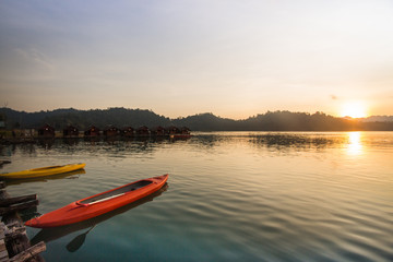 Kayak boat on the lake with beautiful sunset scene