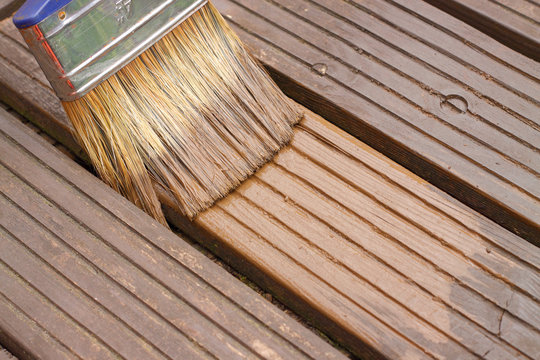Decking painting staining / Painting staining decking in a garden
