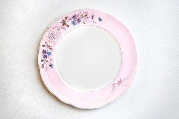 Vintage porcelain plate on a jacquard tablecloth