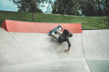 Skate boarder doing tricks at skate park
