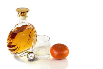 Bottle whiskey and empty tumbler with Mandarin on white backgrou