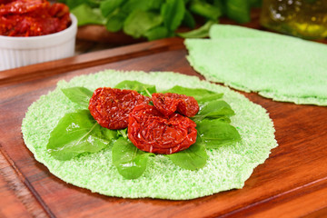 Sun dried and rocket salad on green tapioca