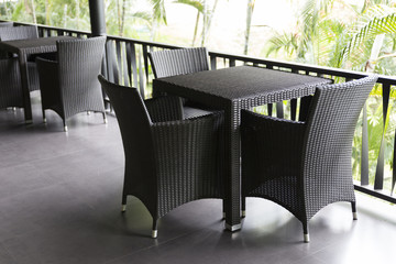 black wicker chair and table at balcony