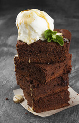 Brownie pieces with ice cream on a dark background