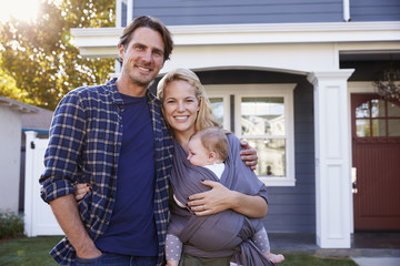 Portrait Of Family Standing Outside House