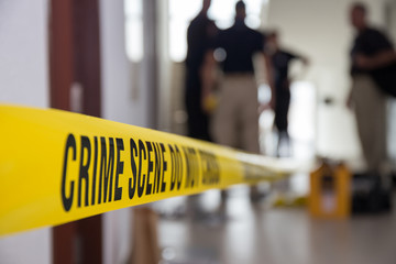 crime scene tape in building with blurred forensic team backgrou - obrazy, fototapety, plakaty