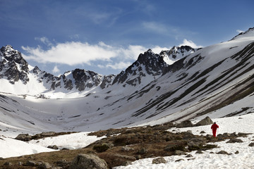 Hiker at snowy mountains in evening