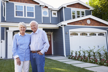 Portrait Of Senior Couple Standing Outside House - Powered by Adobe