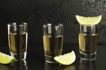 Tequila with salt and lime on a dark background