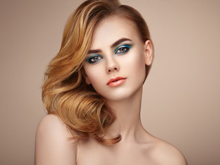 Naklejka premium Portrait of beautiful sensual woman with elegant hairstyle. Perfect makeup. Beauty fashion. Eyelashes. Lips. Cosmetic Eyeshadow