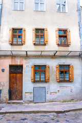Fototapeta na wymiar old city building with shuttered windows