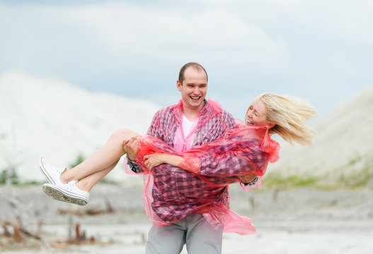 The young man holds the girlfriend on hands.