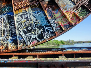 Industrial old metal train drawbridge with vibrant graffiti in Providence, RI