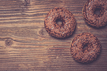 Colorful donuts on wooden table