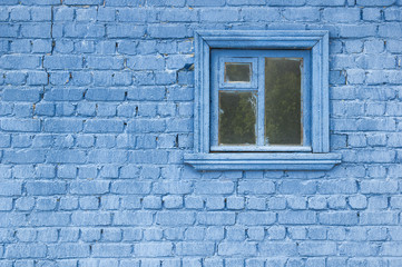 Blue painted brick wall and closed window