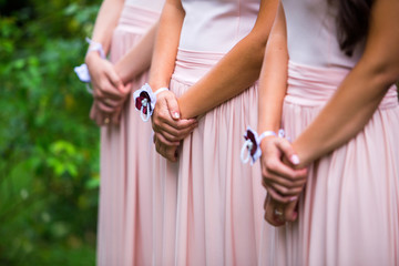 Hands of bridesmaids during the ceremony