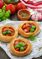 Homemade pie of puff pastry with tomatoes, Basil and spices