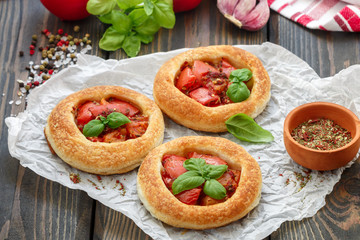 Homemade pie of puff pastry with tomatoes, Basil and spices
