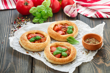 Homemade pie of puff pastry with tomatoes, Basil and spices