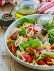 Warm salad of Farfalle with mushrooms and tomatoes 
