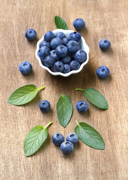 Fresh blueberries with mint leaves. Top view. Vintage style