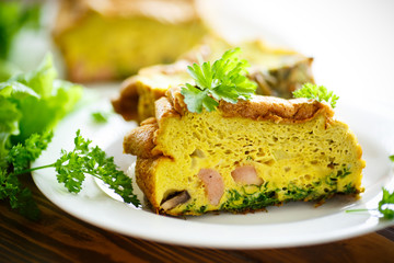 baked omelette with sausages and greens