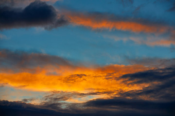 Sunset orange clouds in a blue sky