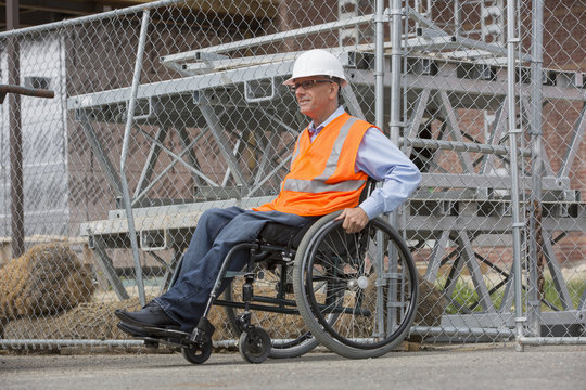 Caucasian engineer in wheelchair on construction site
