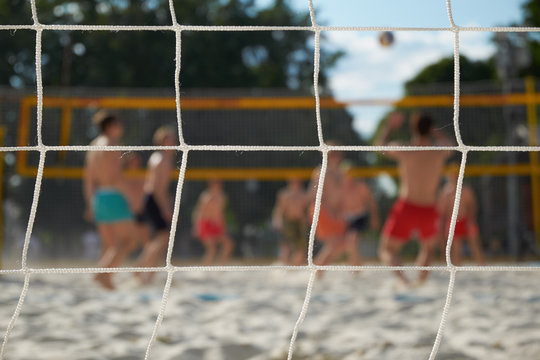 people playing beach volleyball defocused image