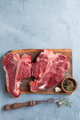 Thick raw T-bone steak with seasoning