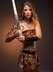 Beautiful woman with sword . Fantasy and legend. Standing in fighting stance.