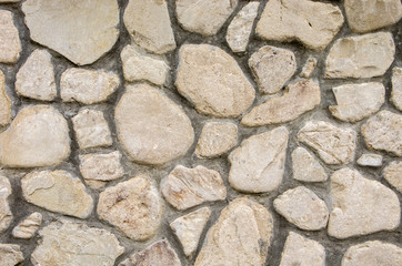 The texture of the stone wall.