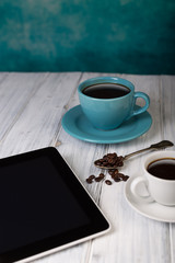 Coffee and tablet on the table