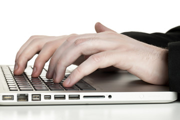 human hand typing on laptop keyboard