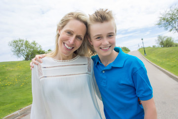 summer portrait of mother and son outside on a road